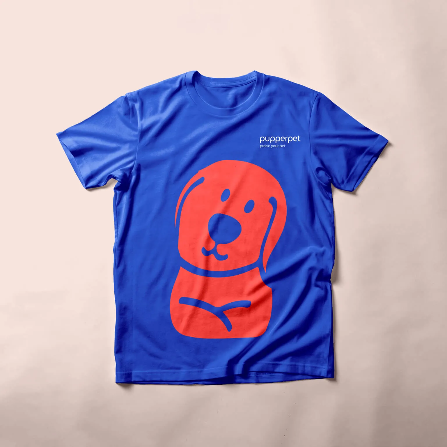 Blue Pupperpet t-shirt printed with a red dog mascot illustration
